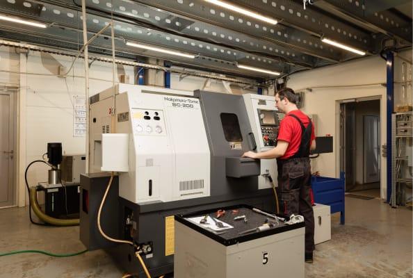 Engeneer is operating CNC turning machine